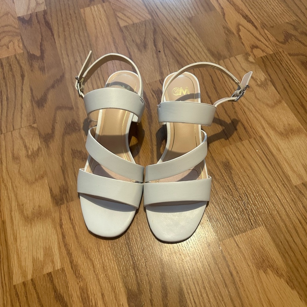White sandal with small heel.